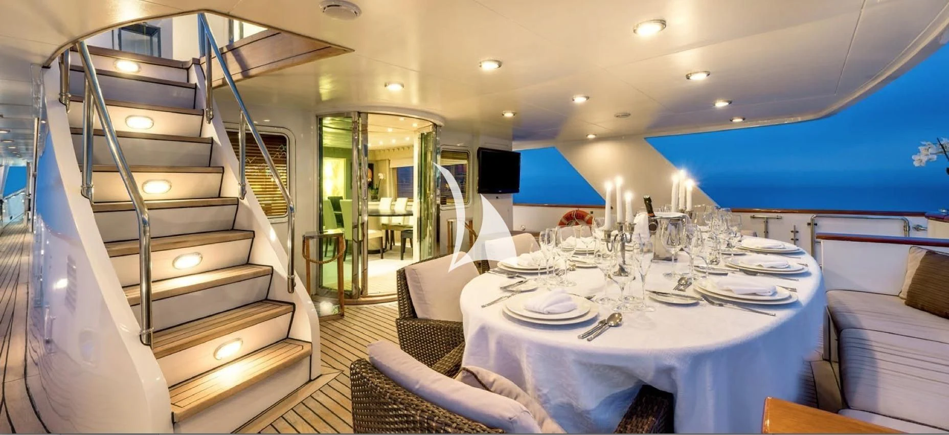 a dining room with a large table and chairs aboard SUPERMAX Yacht for Sale