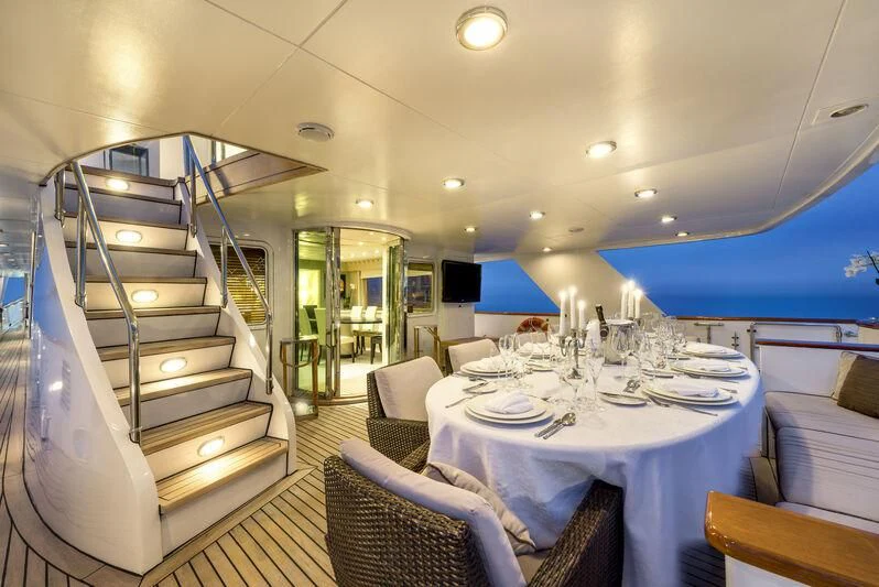 a dining room with a ladder aboard SUPERMAX Yacht for Sale