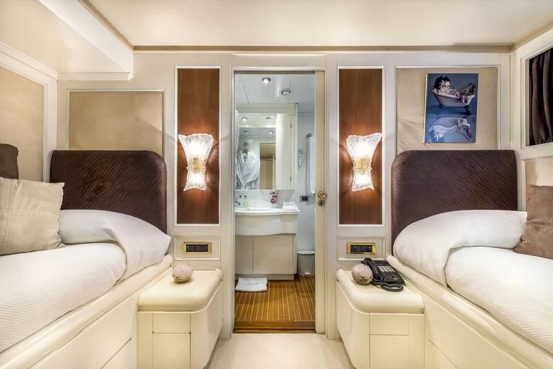 a living room with a white couch and a mirror aboard SUPERMAX Yacht for Sale