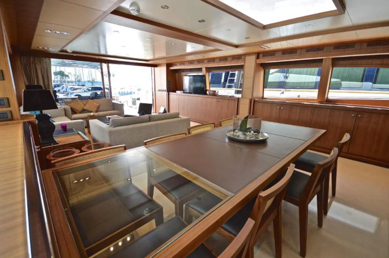 a large living room with a table and chairs aboard TAURUS Yacht for Sale