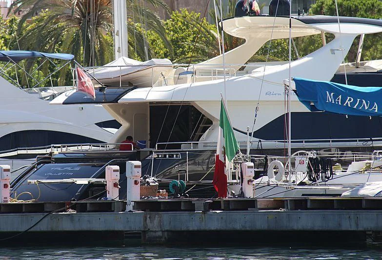a boat docked at a pier aboard TAURUS Yacht for Sale