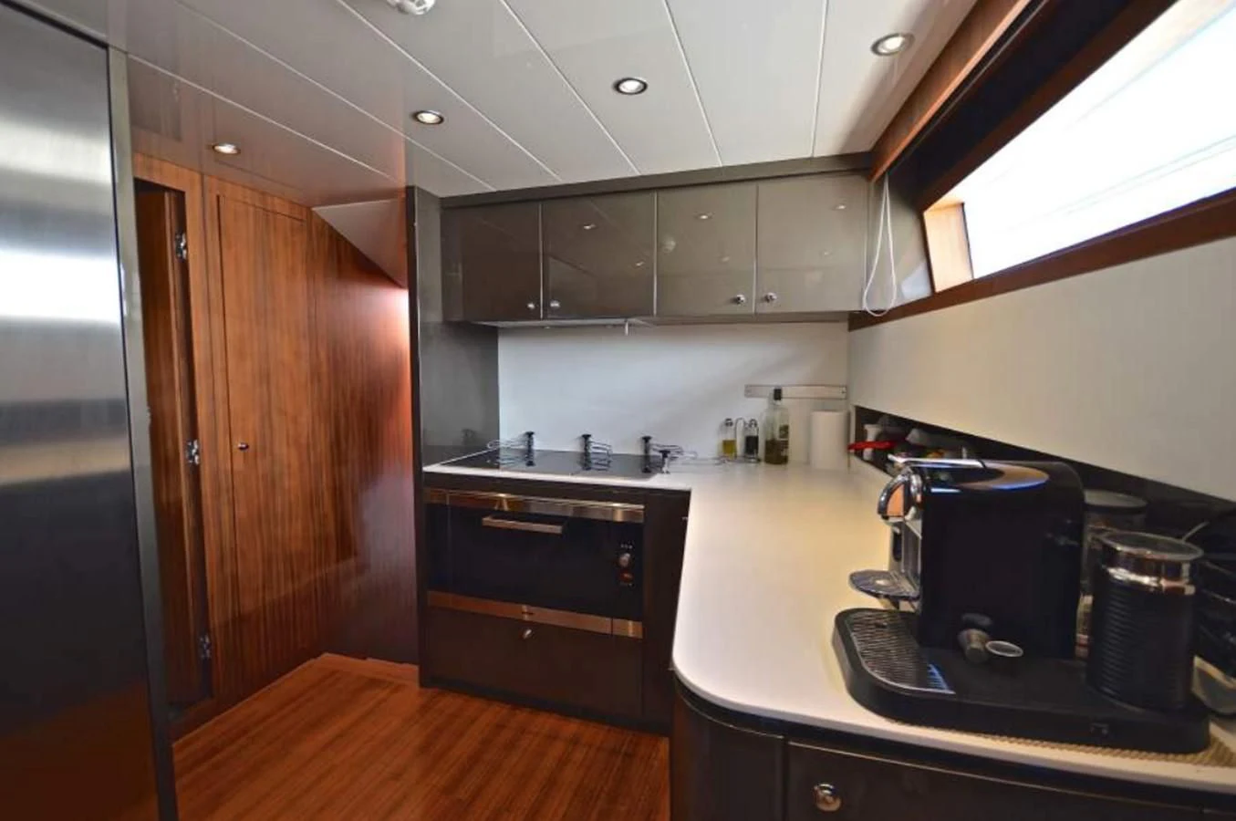 a kitchen with black appliances aboard TAURUS Yacht for Sale
