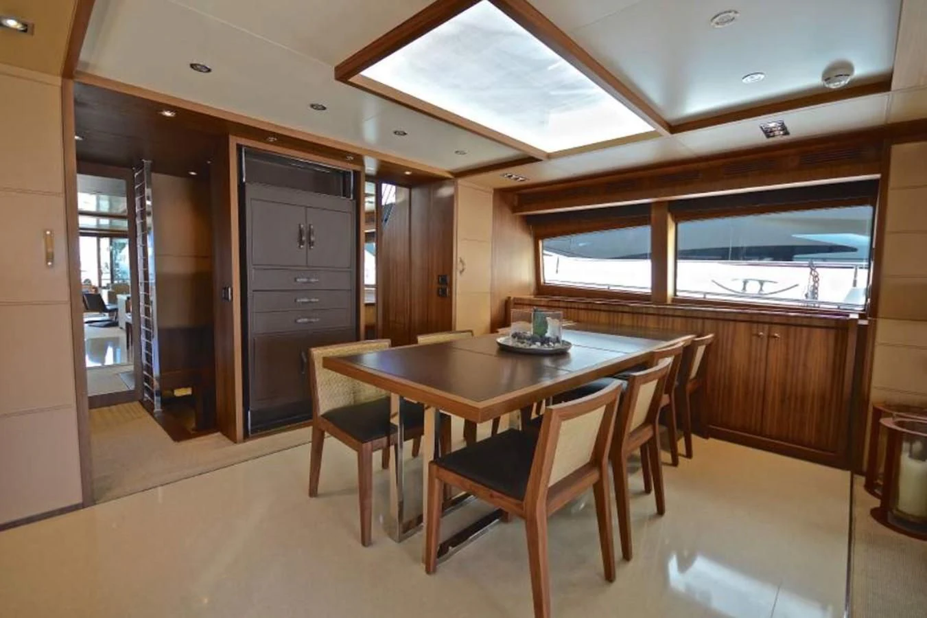 a dining table and chairs in a room with a door open aboard TAURUS Yacht for Sale