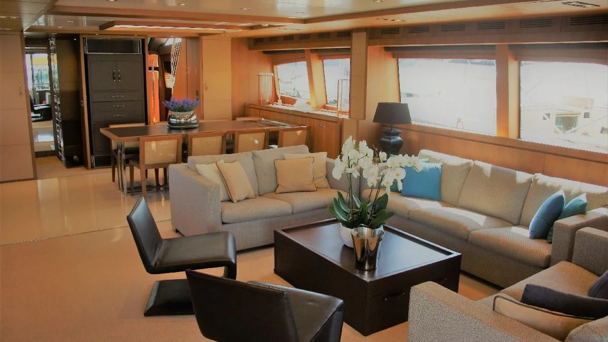 a living room with a couch and a coffee table aboard TAURUS Yacht for Sale