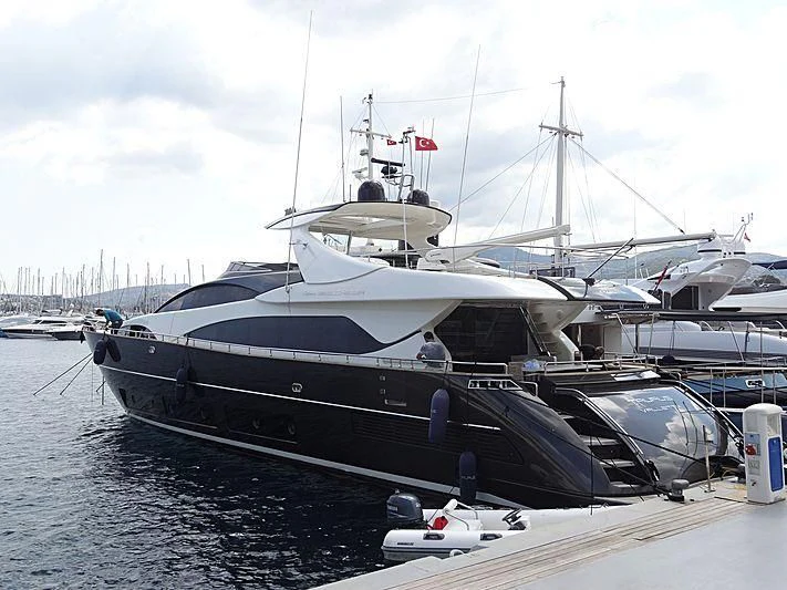 a large boat docked at a pier aboard TAURUS Yacht for Sale