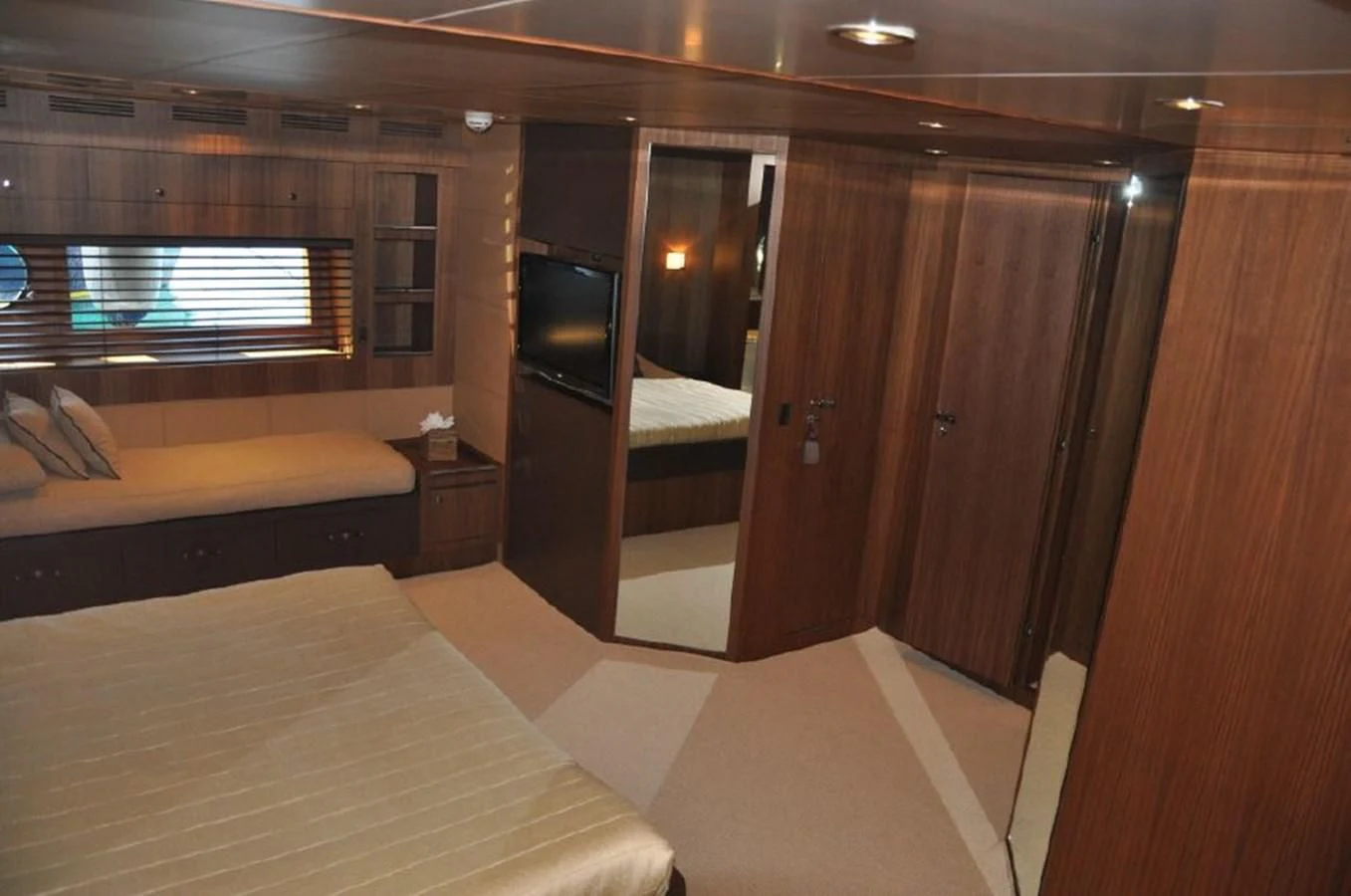 a room with a bed and a tv aboard TAURUS Yacht for Sale