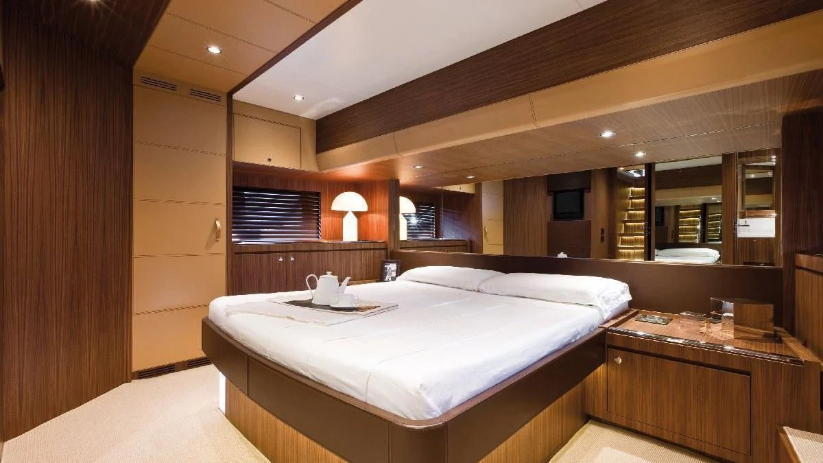 a room with a bed and a desk aboard TAURUS Yacht for Sale