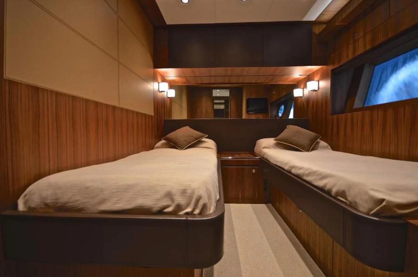 a room with beds and a tv aboard TAURUS Yacht for Sale