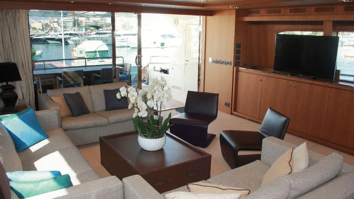 a living room with a couch and a television aboard TAURUS Yacht for Sale