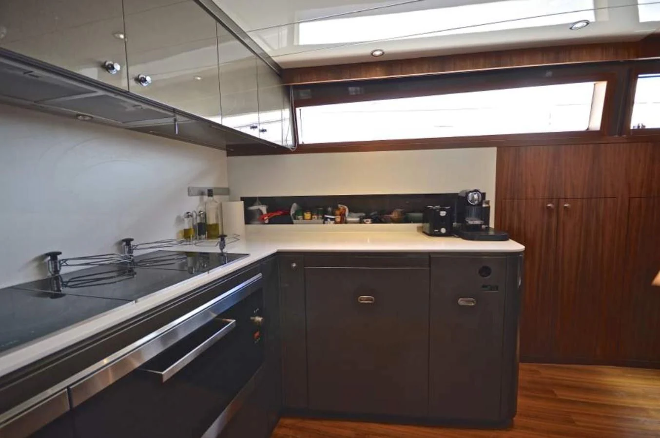 a kitchen with black cabinets aboard TAURUS Yacht for Sale