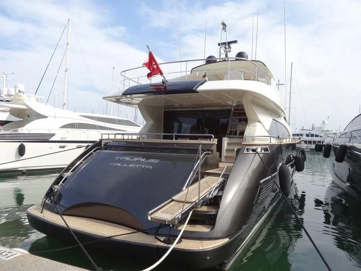 a boat docked at a pier aboard TAURUS Yacht for Sale