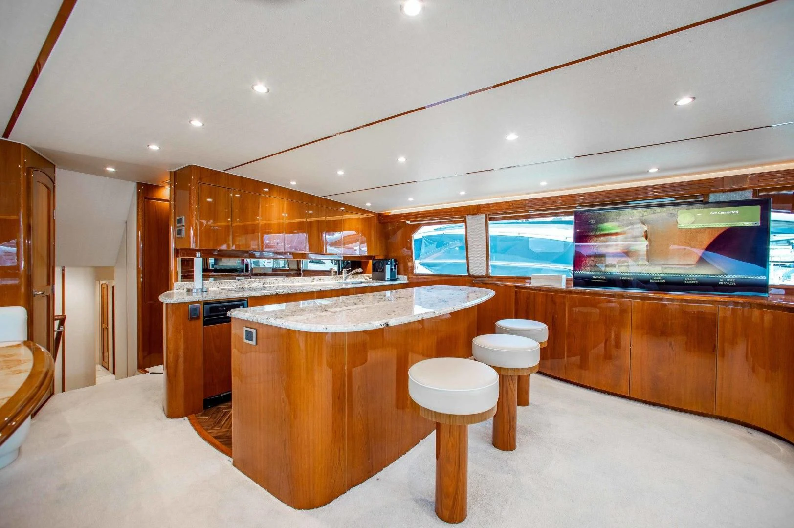 a room with a table and tv aboard BIMINI BABE Yacht for Sale