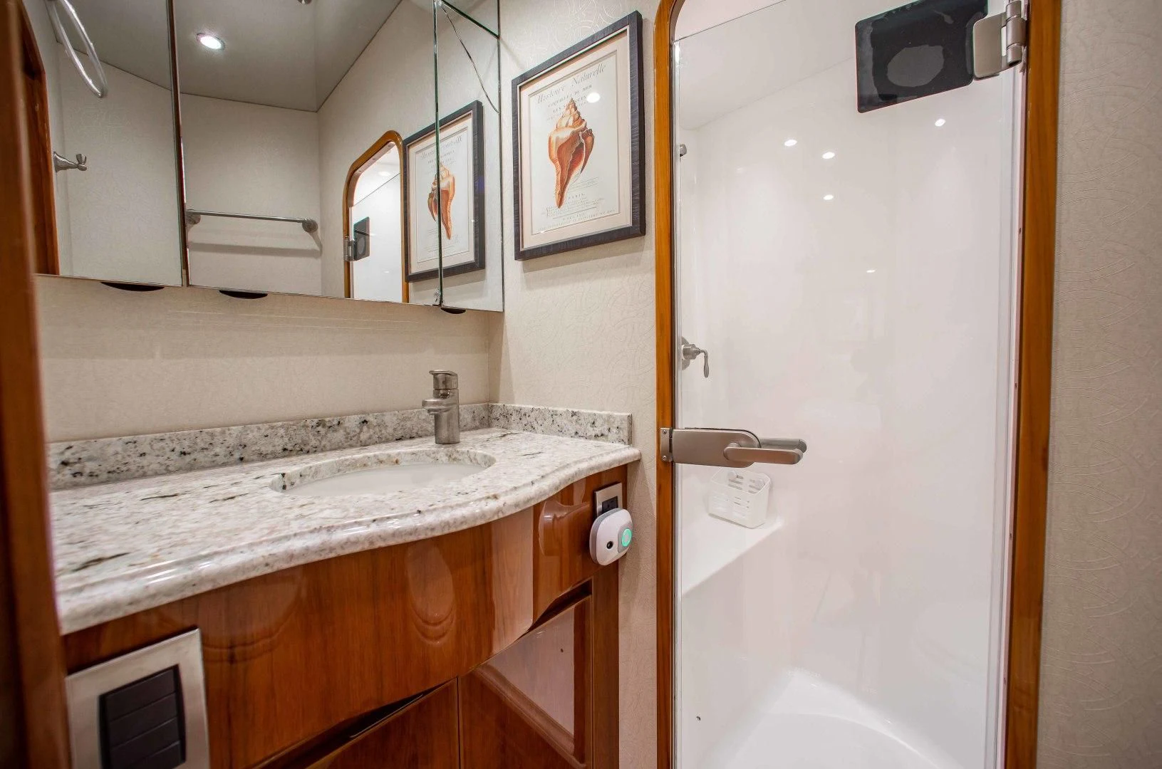 a bathroom with a sink and mirror aboard BIMINI BABE Yacht for Sale