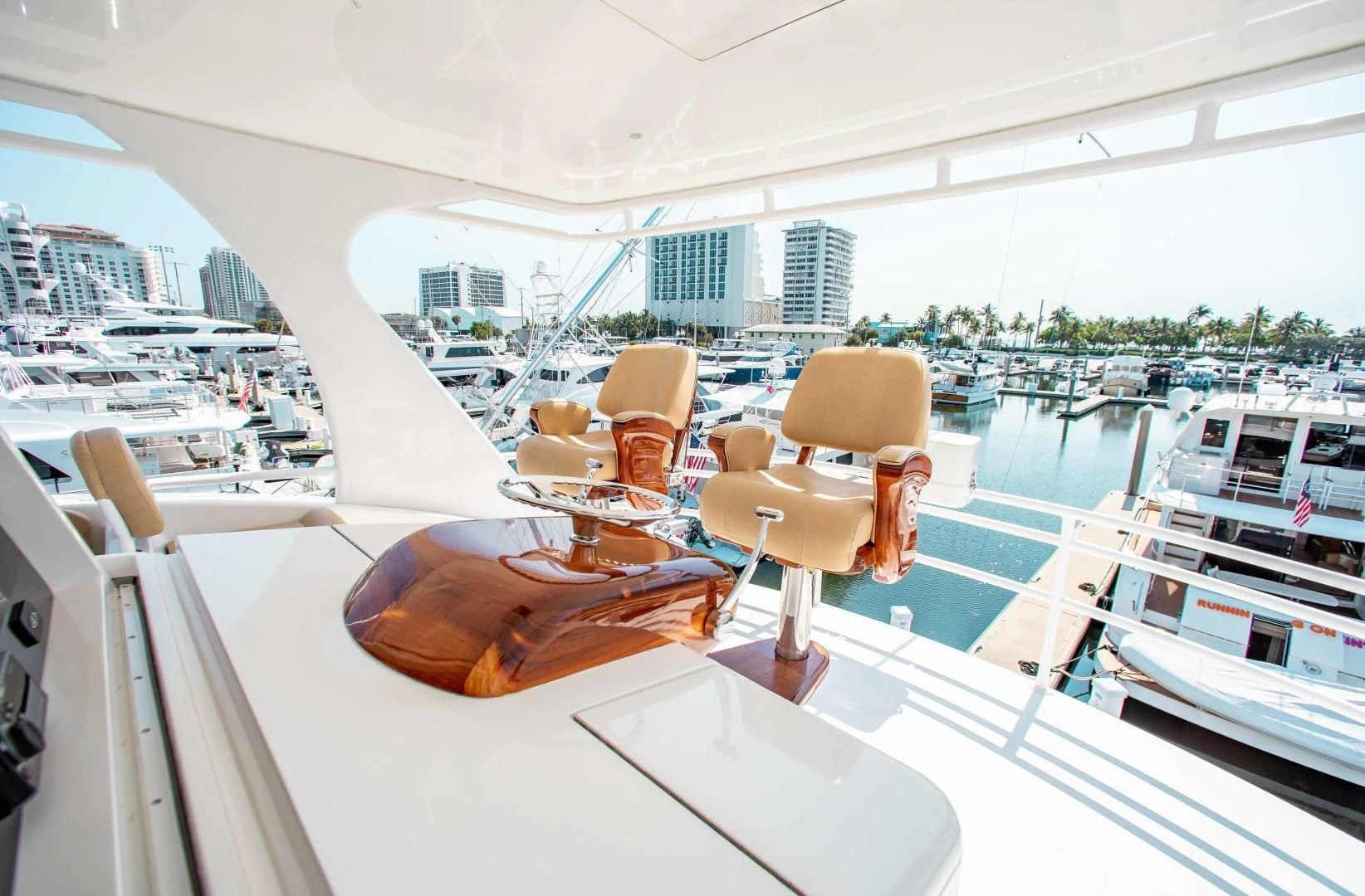 a table with chairs on it next to a large white boat aboard BIMINI BABE Yacht for Sale