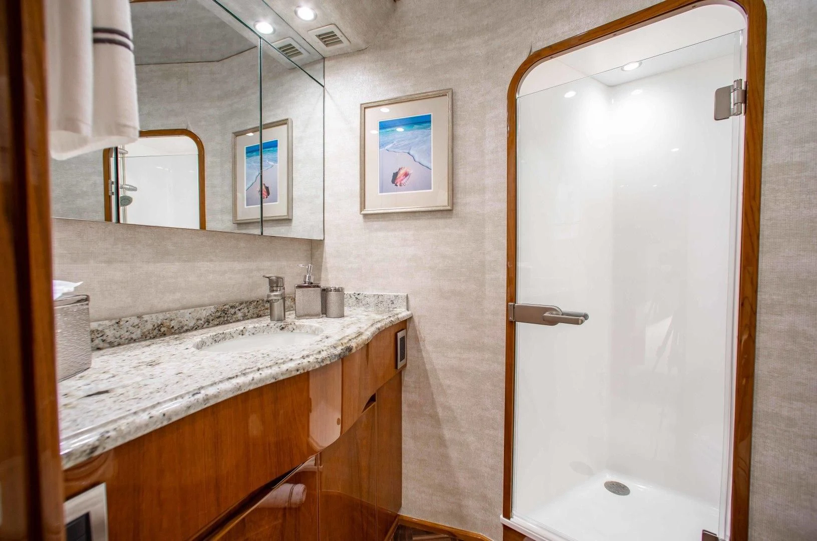a bathroom with a shower unit and sink aboard BIMINI BABE Yacht for Sale