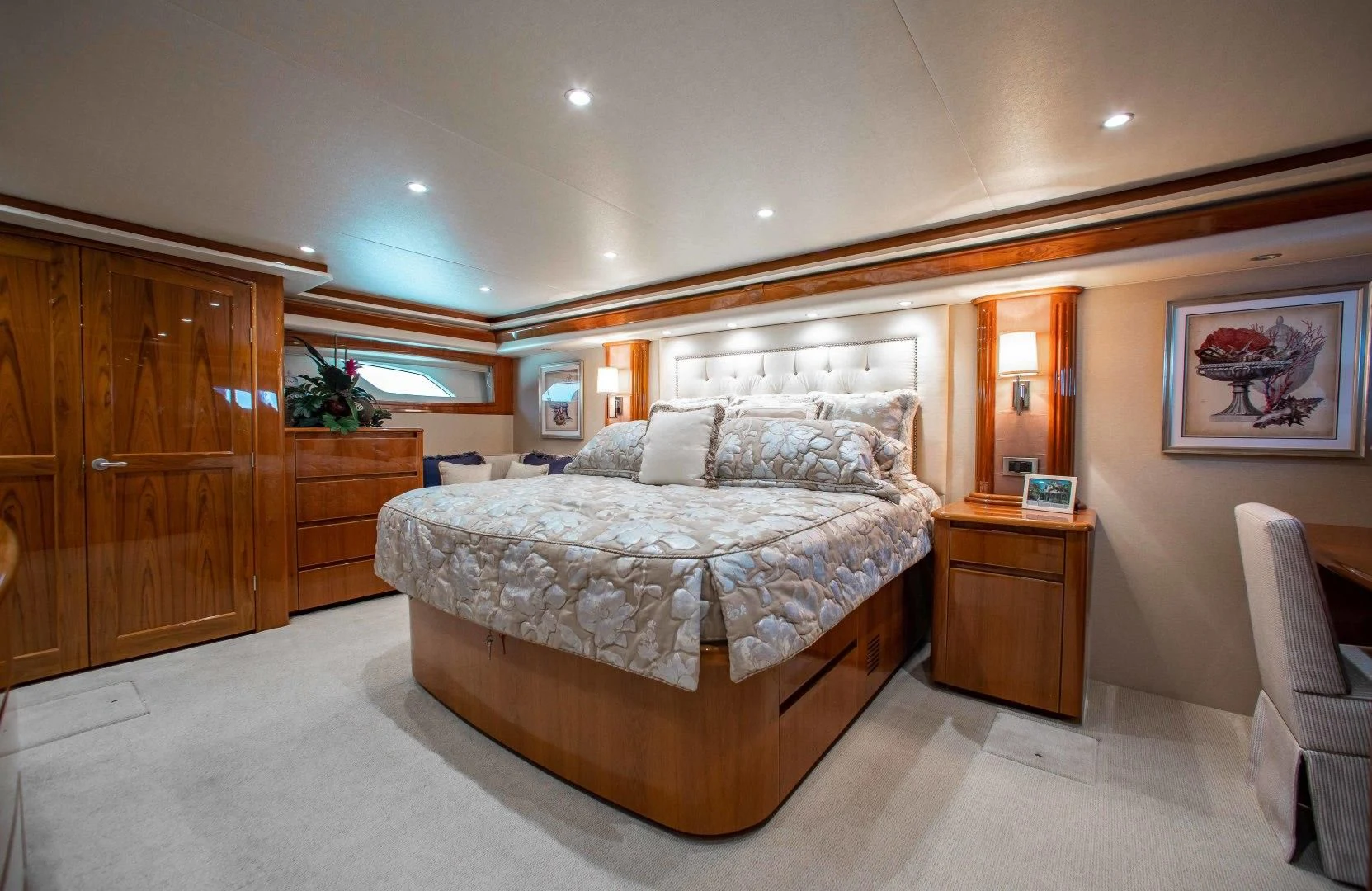 a bedroom with a bed and a desk aboard BIMINI BABE Yacht for Sale
