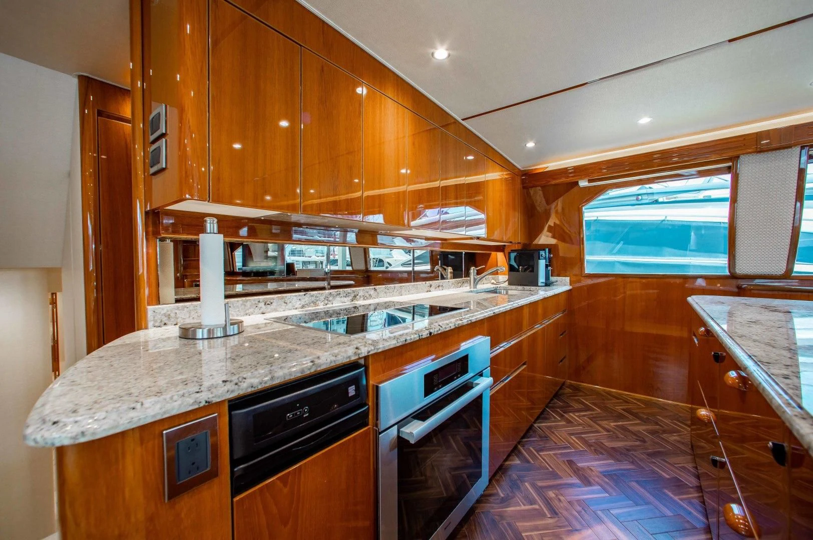 a kitchen with wooden cabinets aboard BIMINI BABE Yacht for Sale