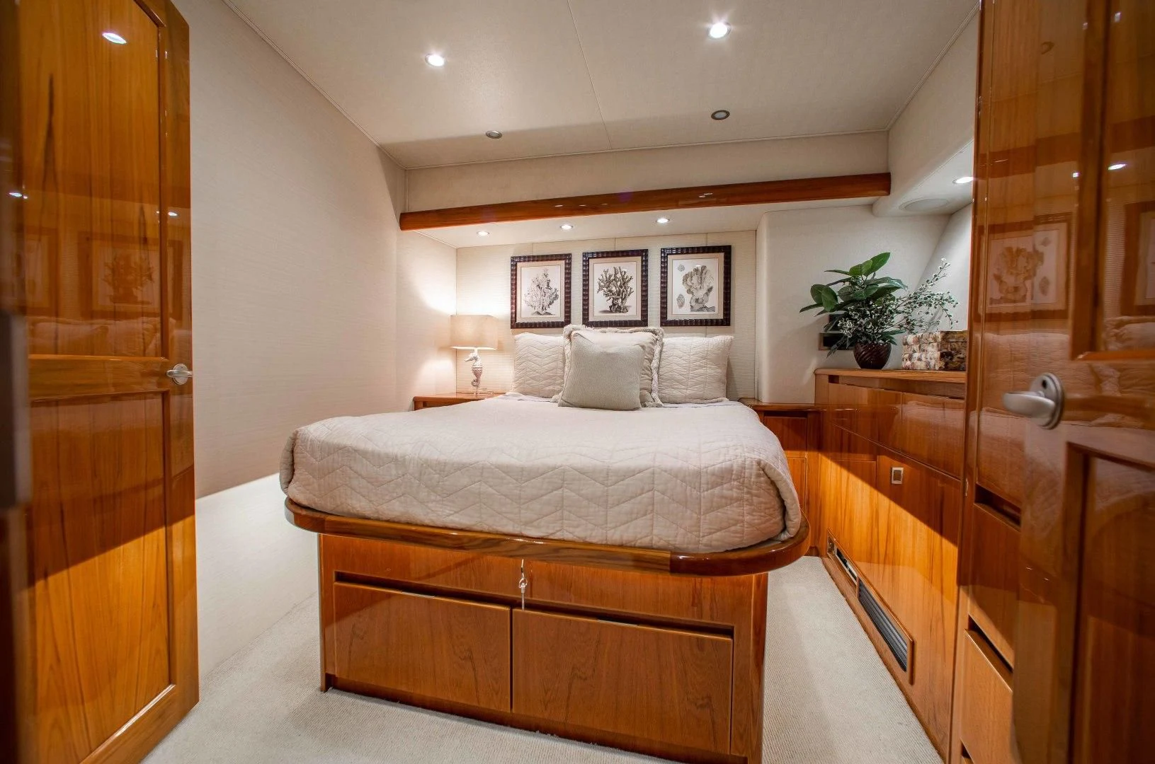a bedroom with a bed and a closet aboard BIMINI BABE Yacht for Sale