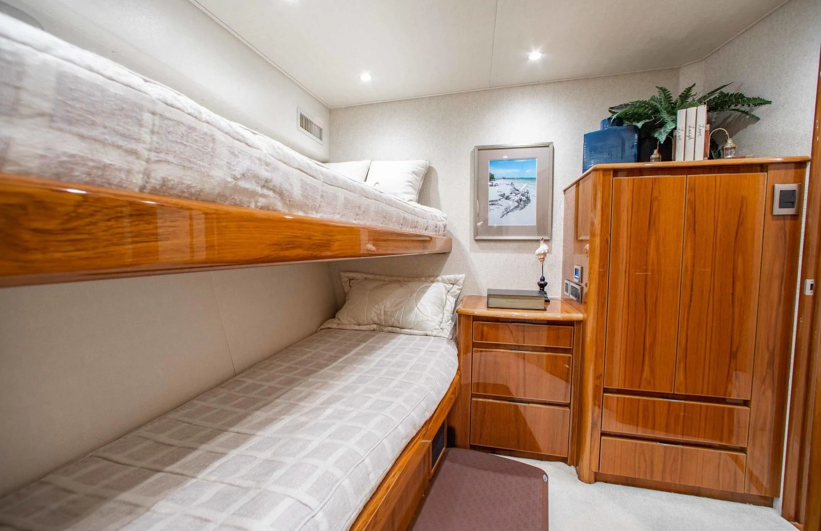 a room with a bed and a dresser aboard BIMINI BABE Yacht for Sale