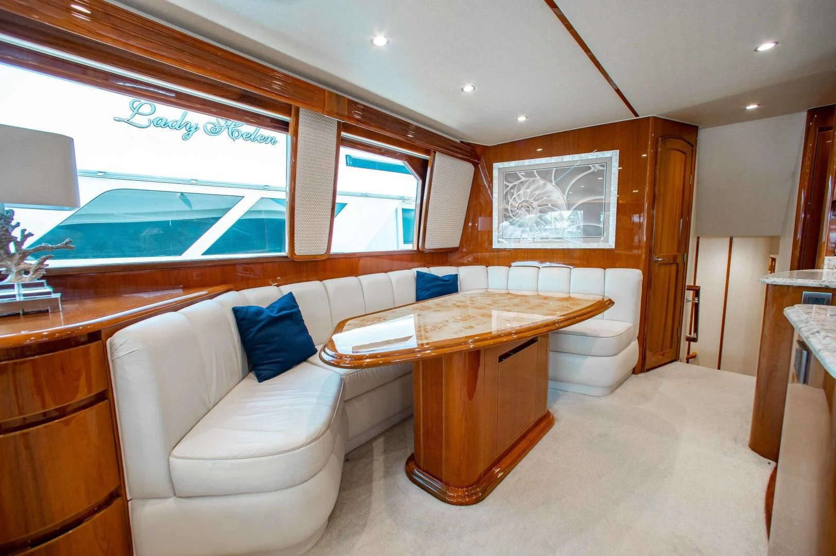 a room with a table and a couch aboard BIMINI BABE Yacht for Sale