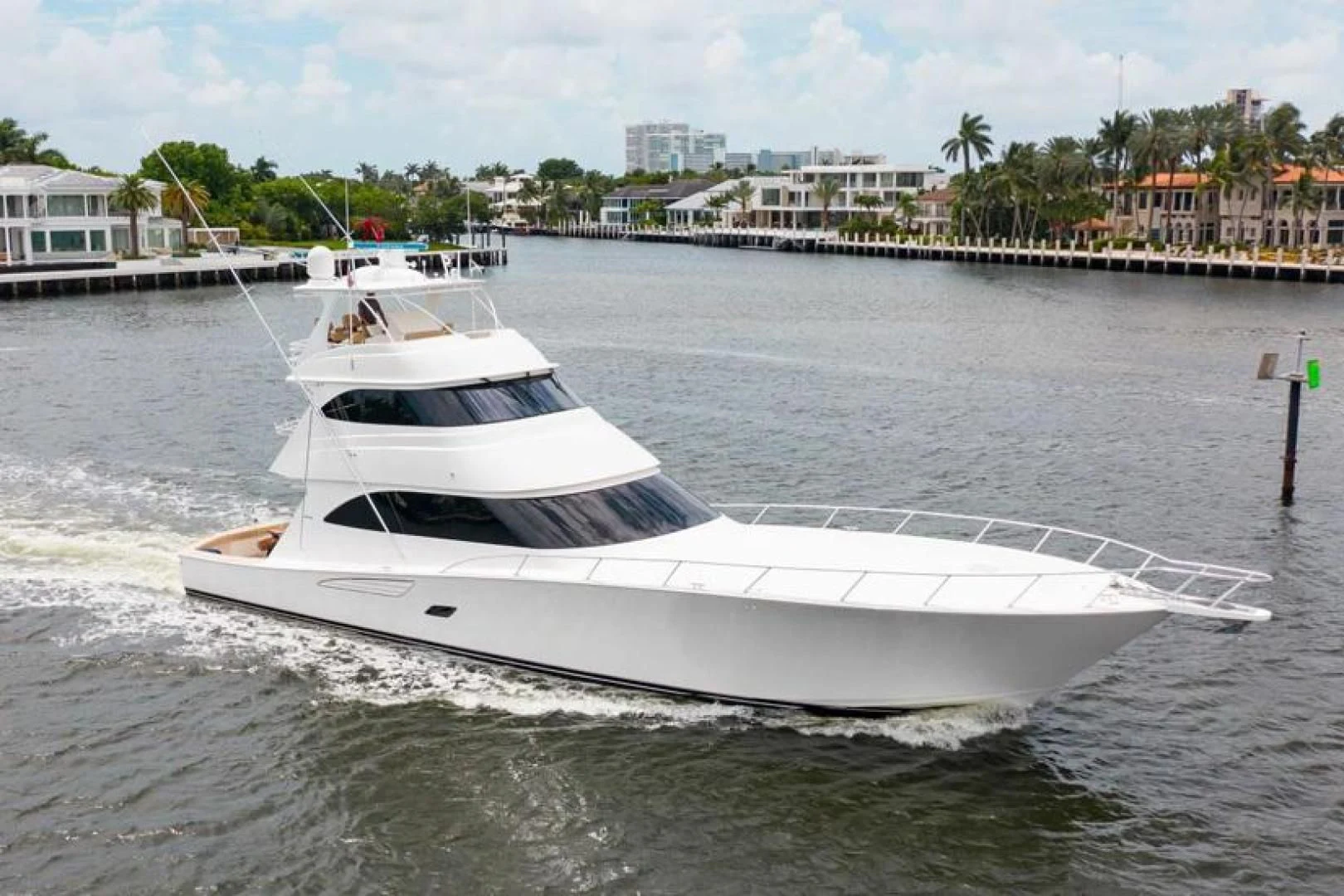 a white yacht in a harbor aboard BIMINI BABE Yacht for Sale