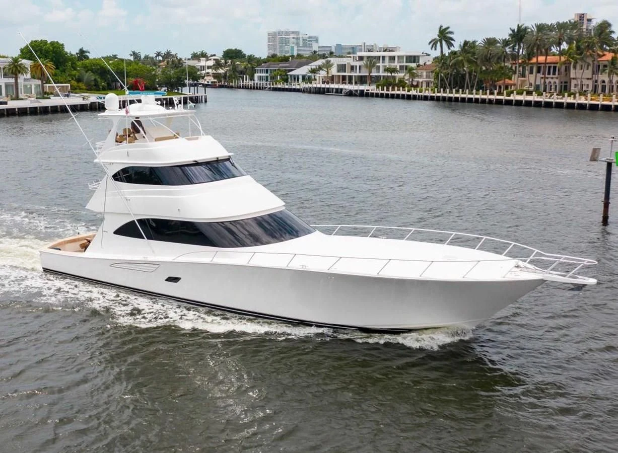 a white boat in a harbor aboard BIMINI BABE Yacht for Sale