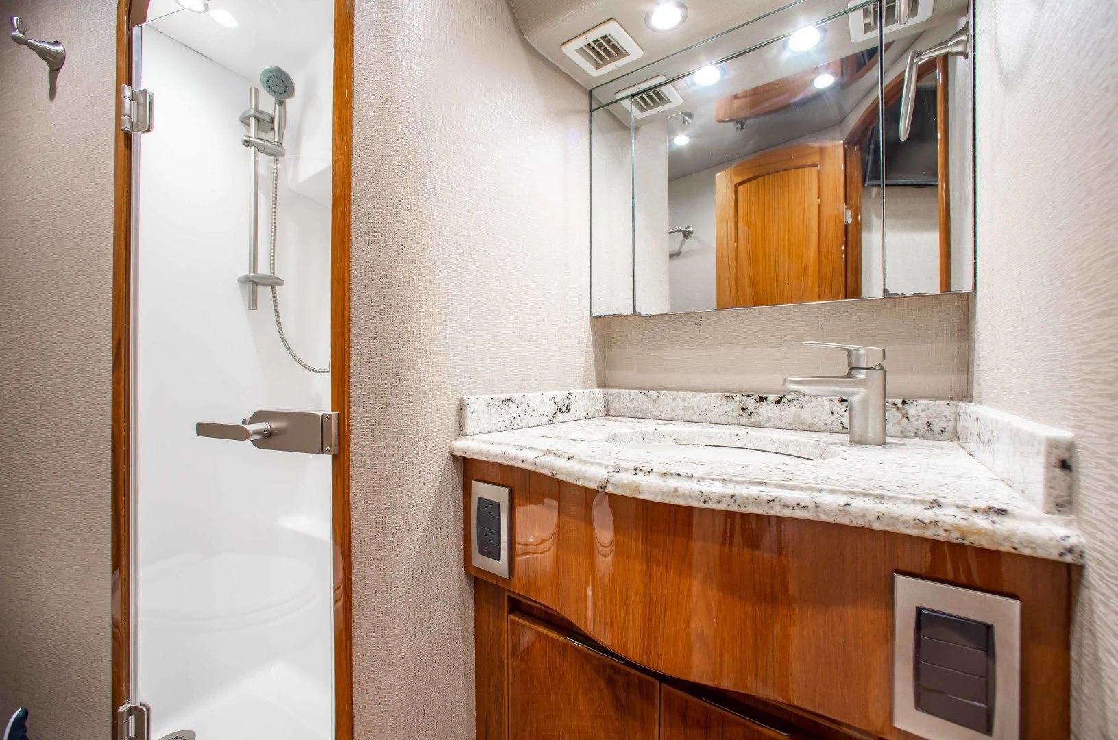 a bathroom with a sink and a mirror aboard BIMINI BABE Yacht for Sale