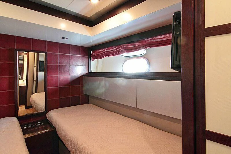a room with a bed and a mirror aboard GEMINIS Yacht for Sale