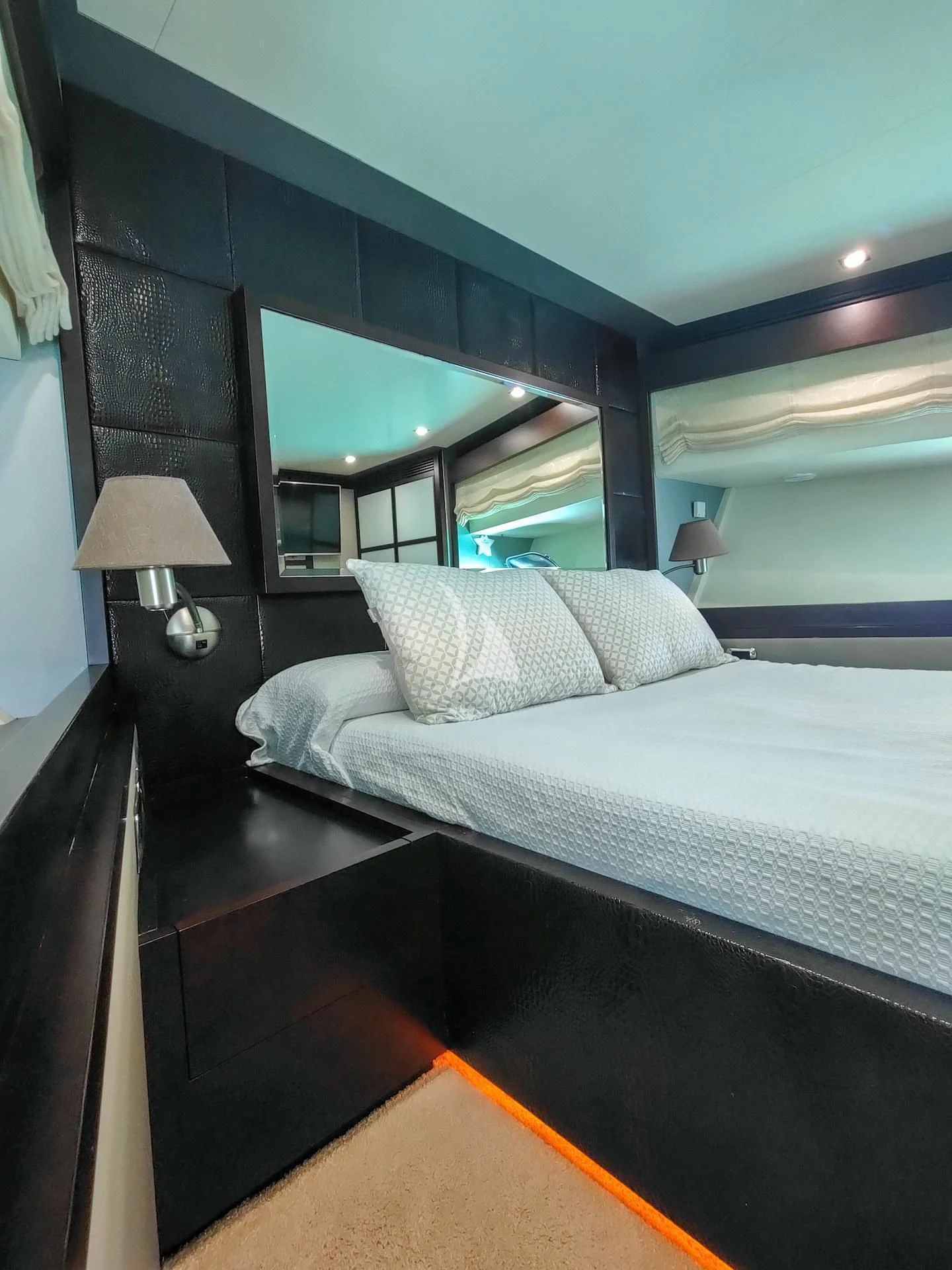 a bed with a white bed spread aboard GEMINIS Yacht for Sale