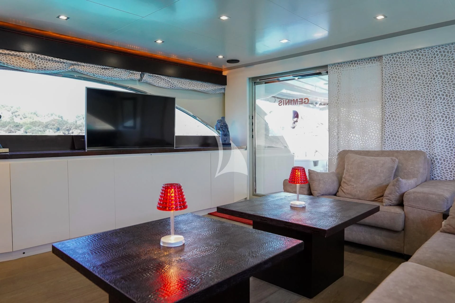 a living room with a table and couches aboard GEMINIS Yacht for Sale