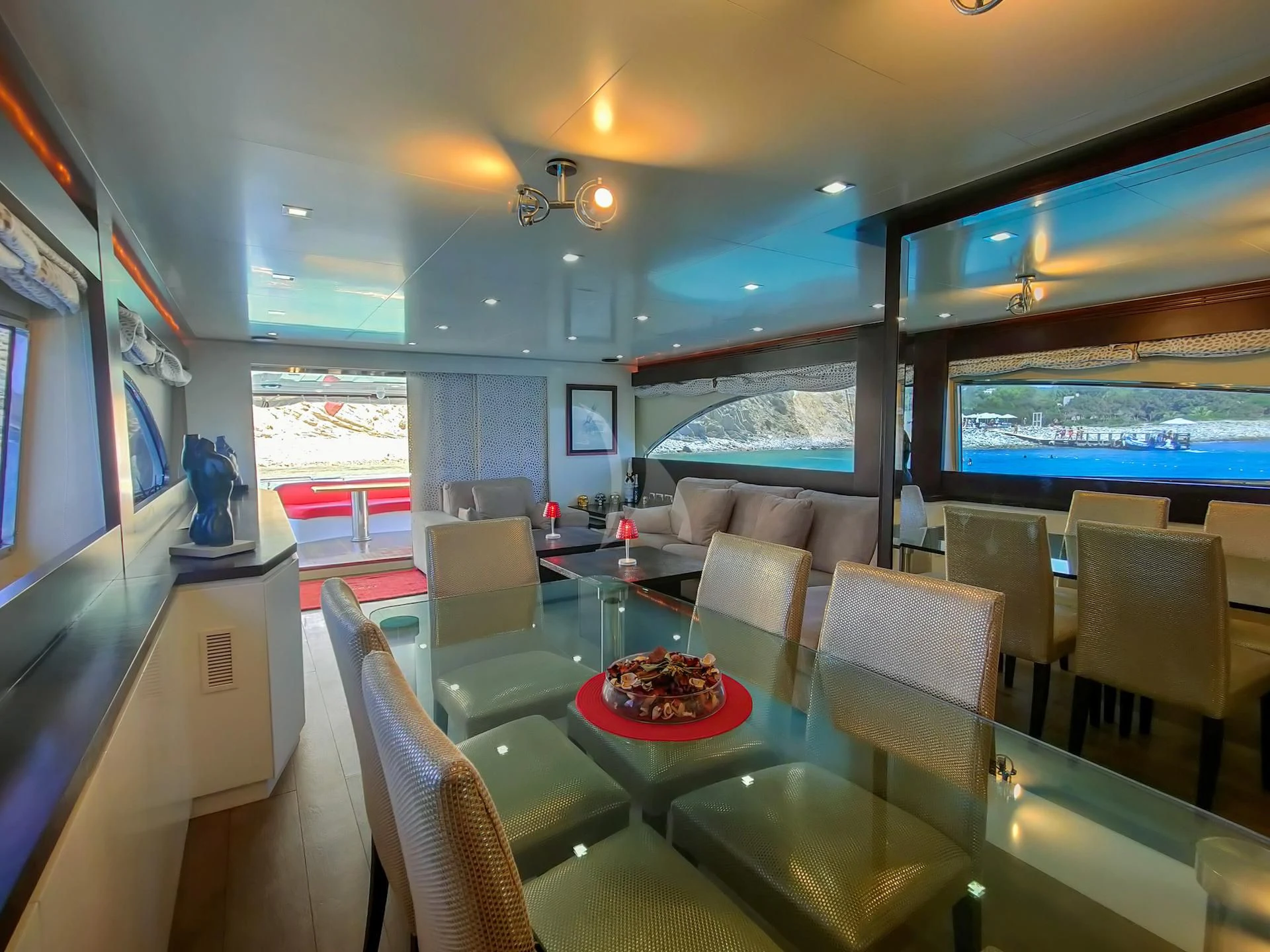 a room with a table and chairs aboard GEMINIS Yacht for Sale