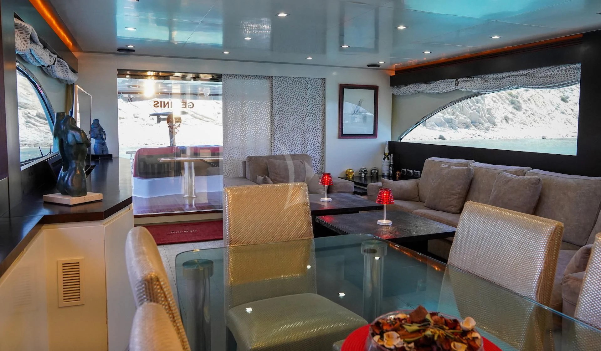 a living room with a large window aboard GEMINIS Yacht for Sale