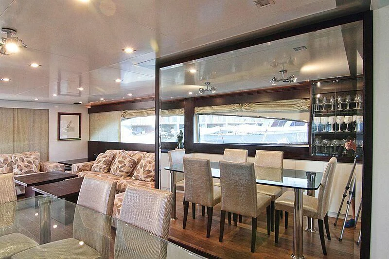 a room with a table and chairs aboard GEMINIS Yacht for Sale