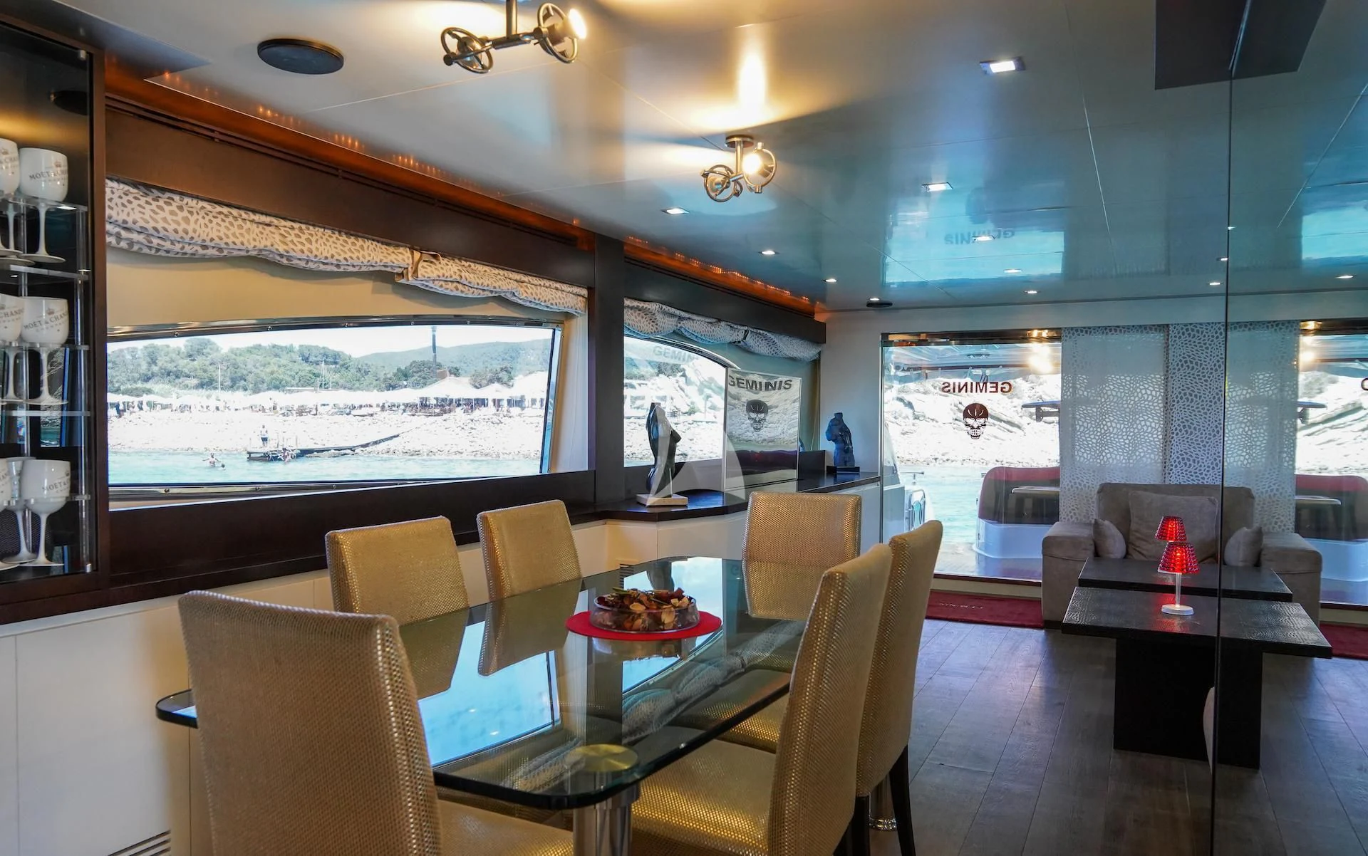 a room with a table and chairs aboard GEMINIS Yacht for Sale