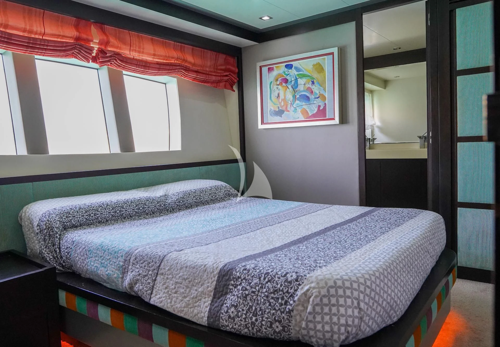 a bed with a blue sheet aboard GEMINIS Yacht for Sale