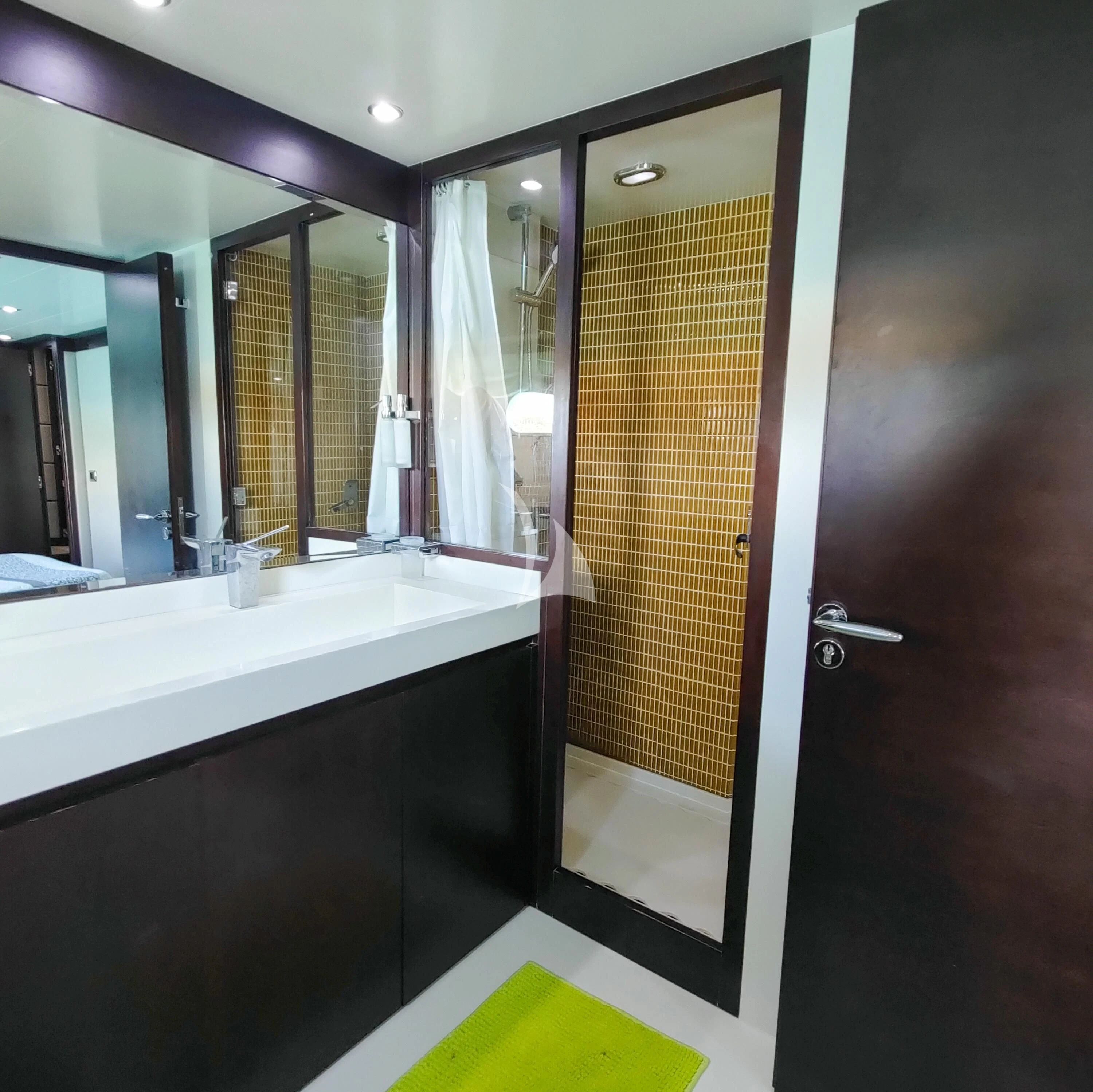 a bathroom with a large mirror aboard GEMINIS Yacht for Sale