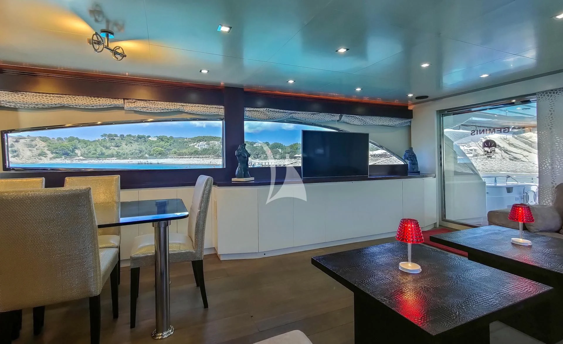 a room with a table and chairs aboard GEMINIS Yacht for Sale