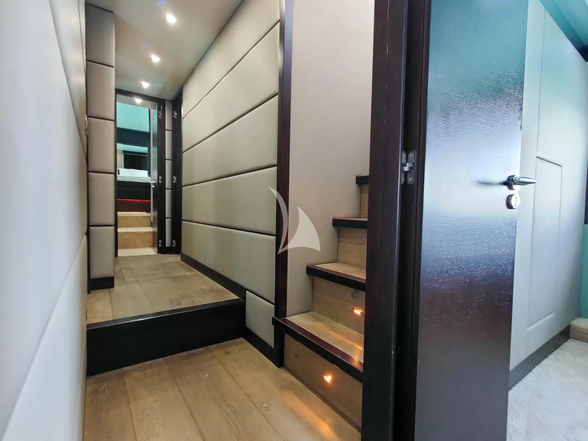 a hallway with a door and a glass door aboard GEMINIS Yacht for Sale