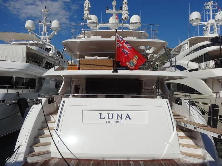 a boat with a flag on it aboard LUNA Yacht for Sale