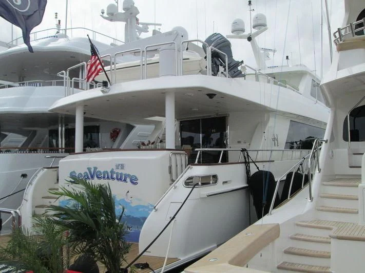 a boat with a flag on the deck aboard DIVERTIMENTO II Yacht for Sale
