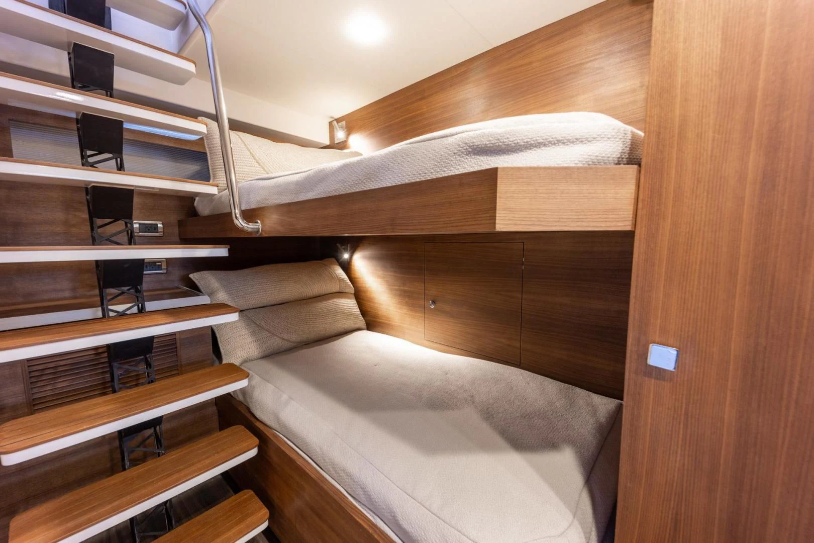 a wooden bunk bed with white sheets aboard MY 3 GALS Yacht for Sale