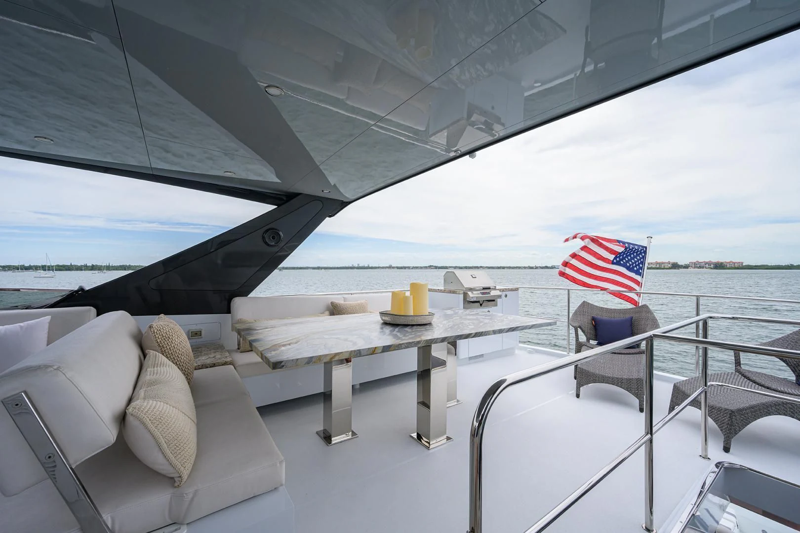 a boat with a table and a flag on it aboard MY 3 GALS Yacht for Sale