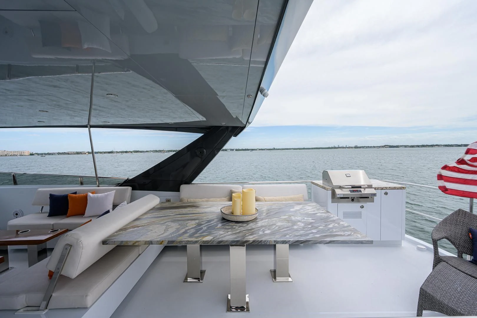 a table on a deck overlooking the ocean aboard MY 3 GALS Yacht for Sale