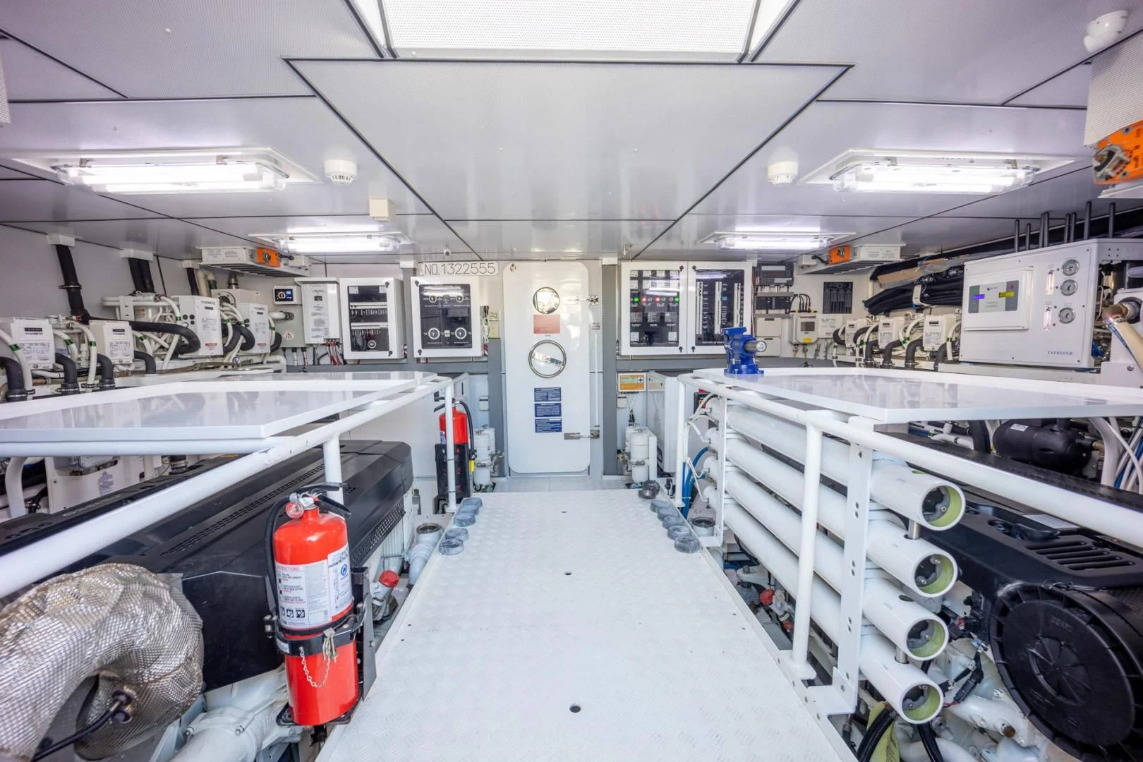 a room with white tables and white cabinets aboard MY 3 GALS Yacht for Sale