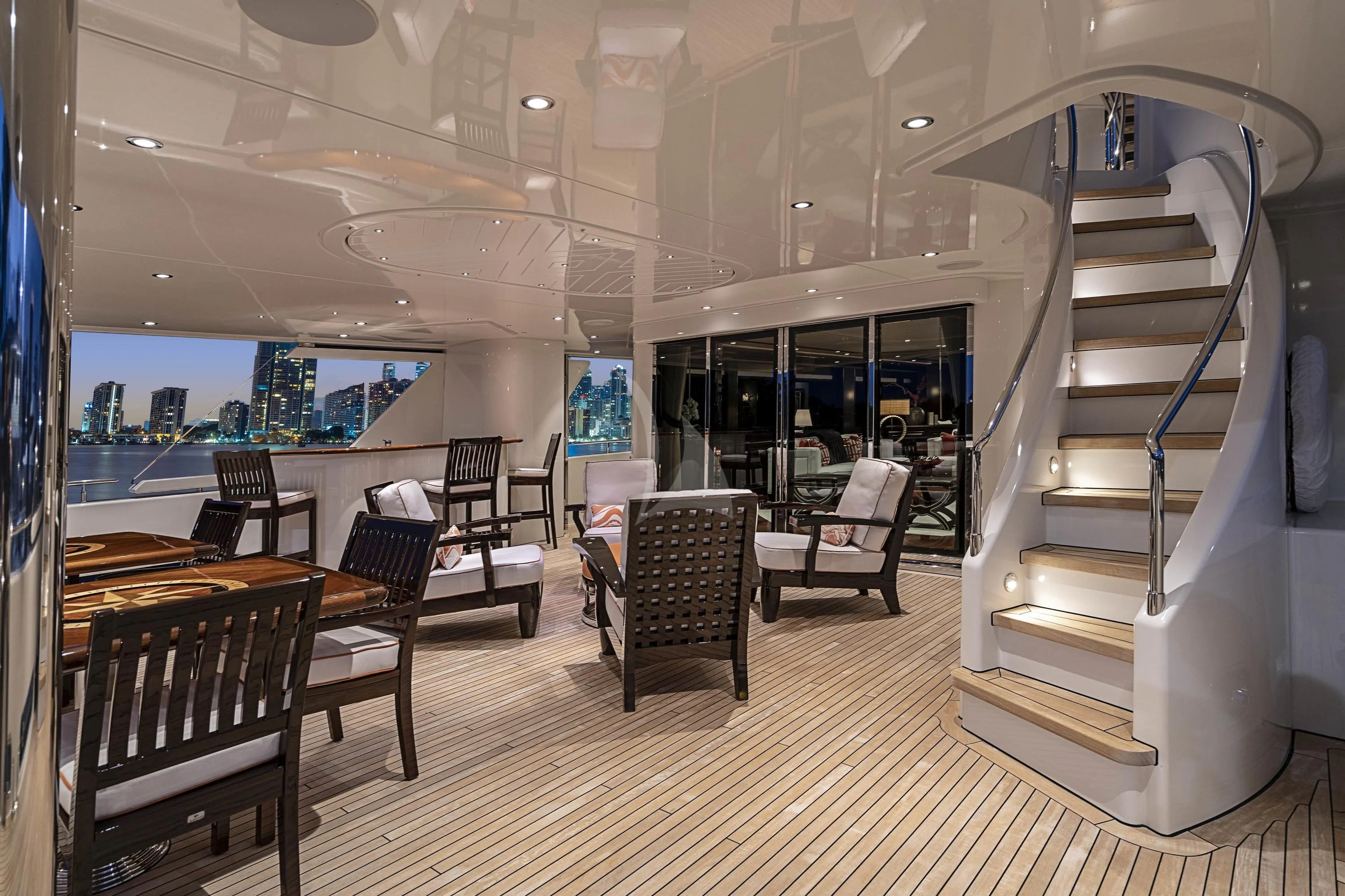 a room with a staircase and chairs aboard DRILLER Yacht for Sale
