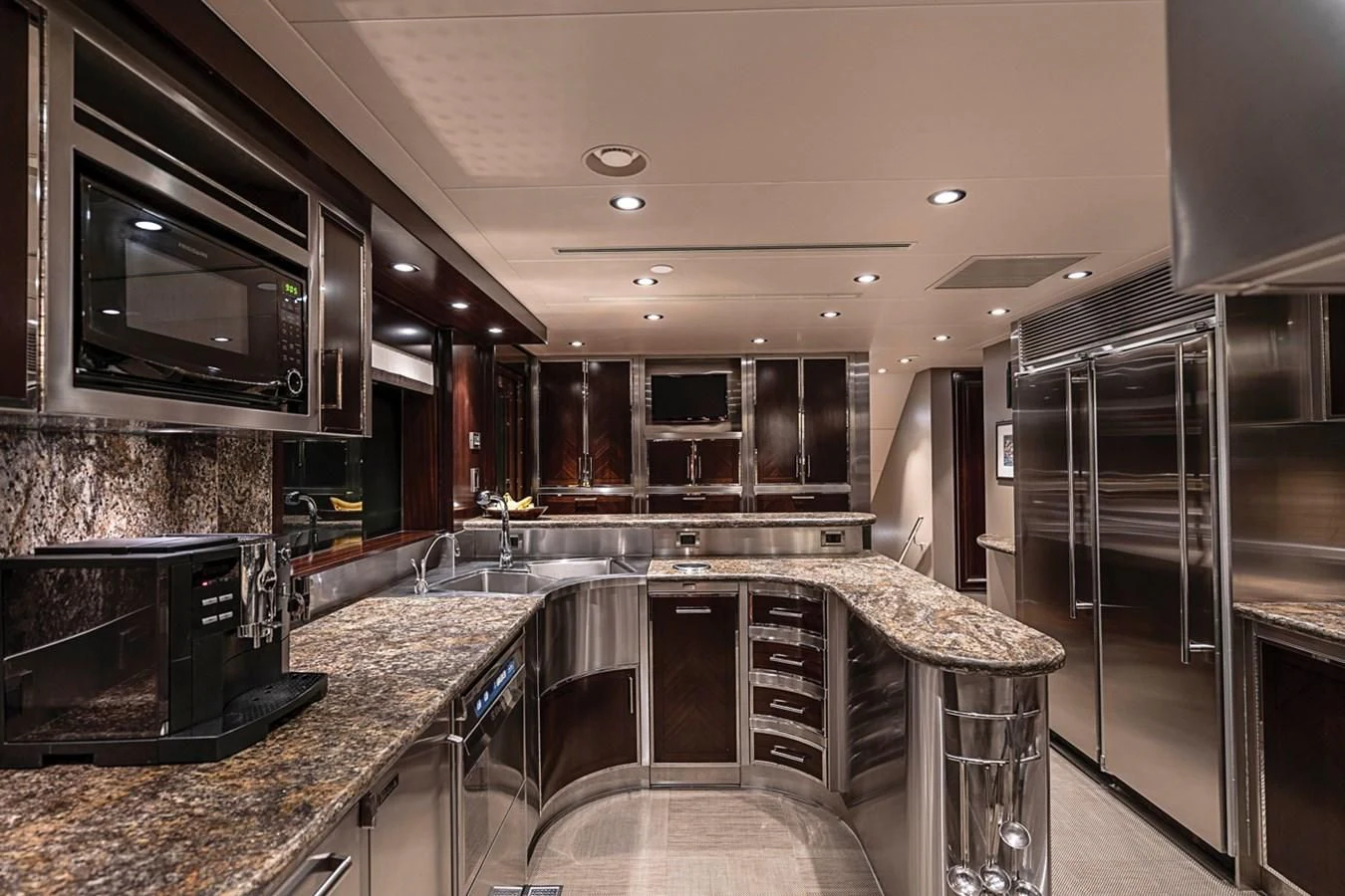 a kitchen with stainless steel appliances aboard DRILLER Yacht for Sale
