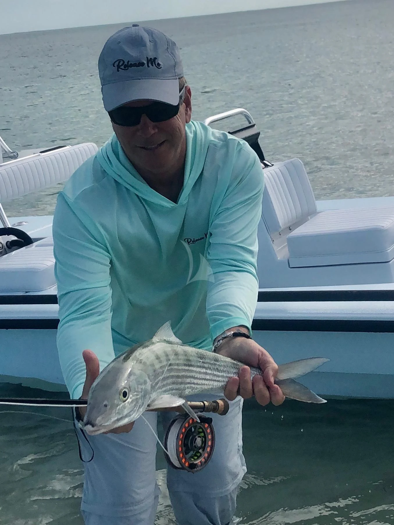 a person holding a fish aboard DRILLER Yacht for Sale