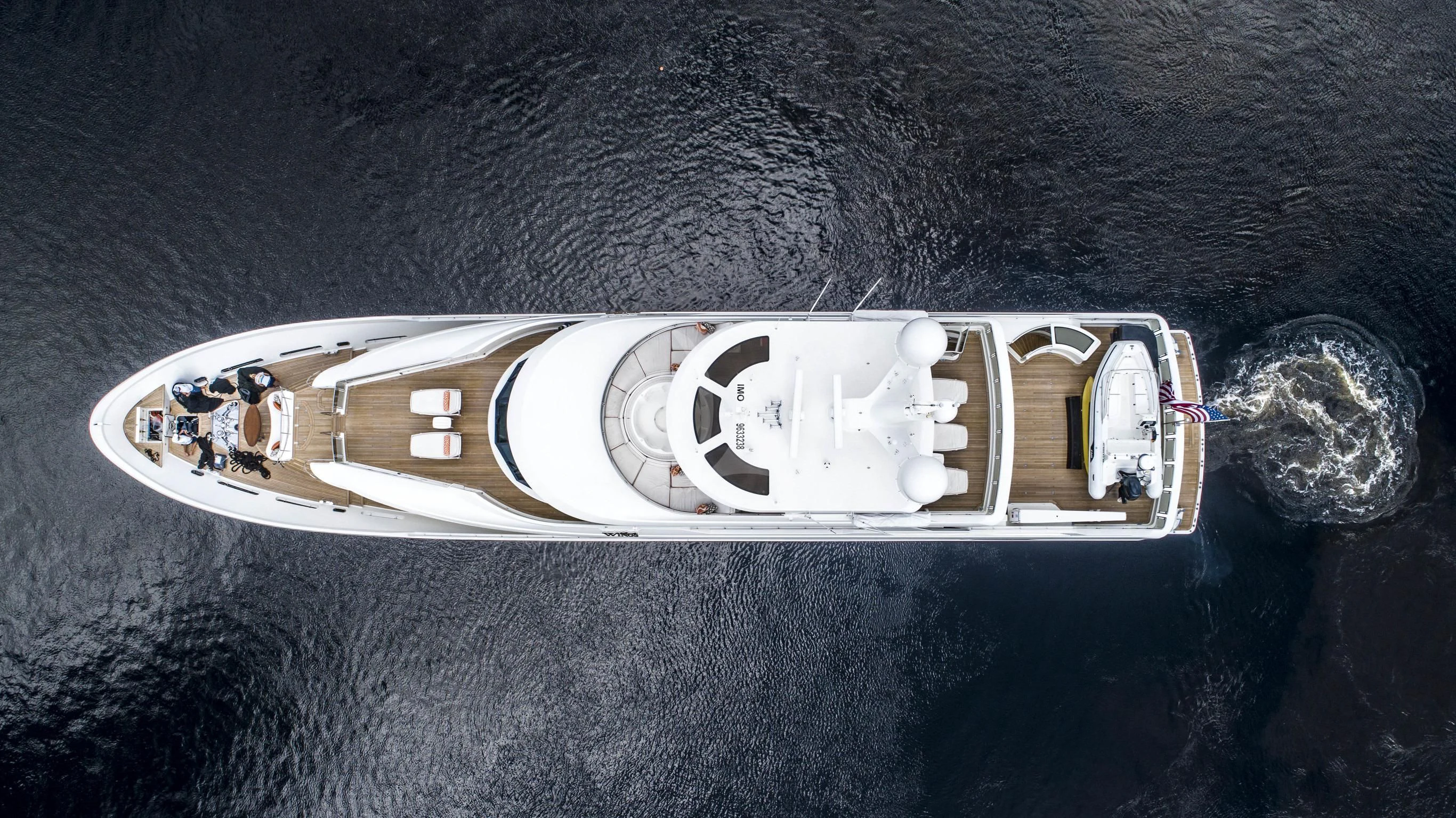 a white rectangular object with a group of people on it aboard DRILLER Yacht for Sale