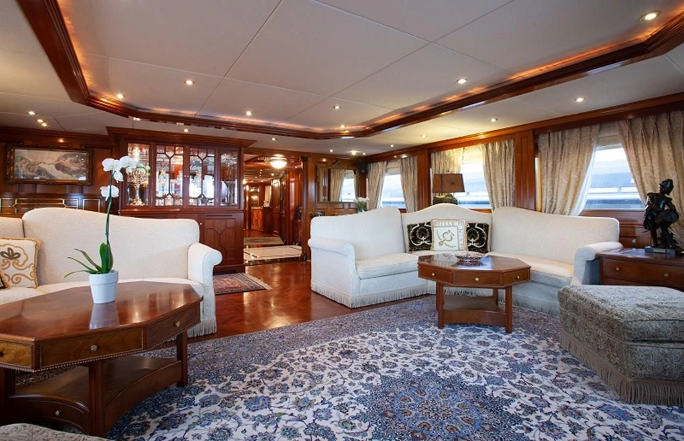 a living room with a large blue rug and a large window aboard BLUE STAR Yacht for Sale