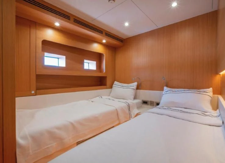a room with two beds aboard MURAL YACHTS 85 TRAWLER Yacht for Sale
